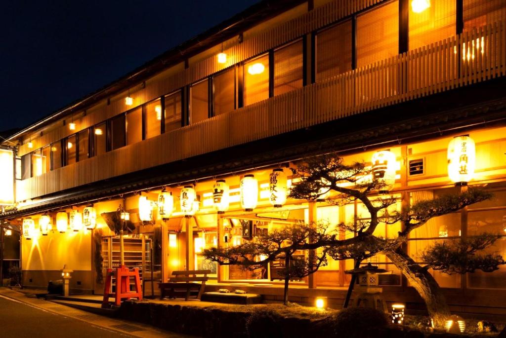 a building with lights on the side of it at night at Kadojin in Tenkawa