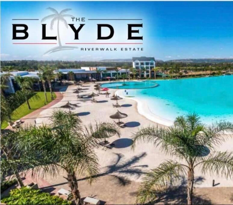 a magazine cover of a beach with palm trees and a resort at Luxury beach lagoon 1 Bedroom apartment in Pretoria