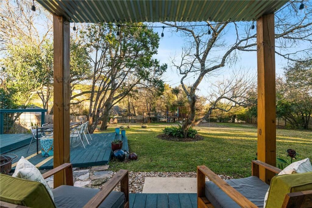 a screened in porch with a view of a yard at 2b1b Hidden Oasis in the Hills- Close to Downtown in Austin