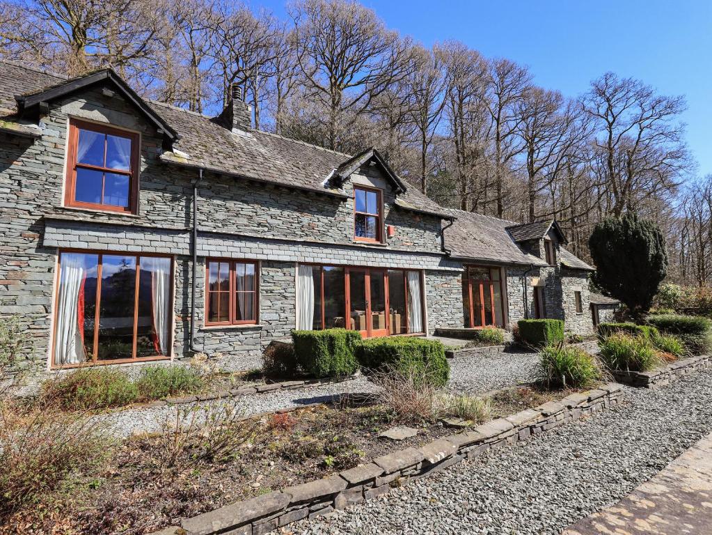 an old stone house on the side of a road at The Stables in Ambleside