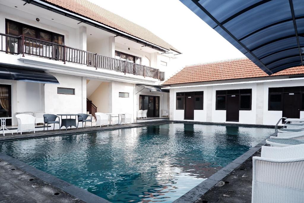 a swimming pool in the middle of a building at Hippo Diving Bali Rooms in Sanur