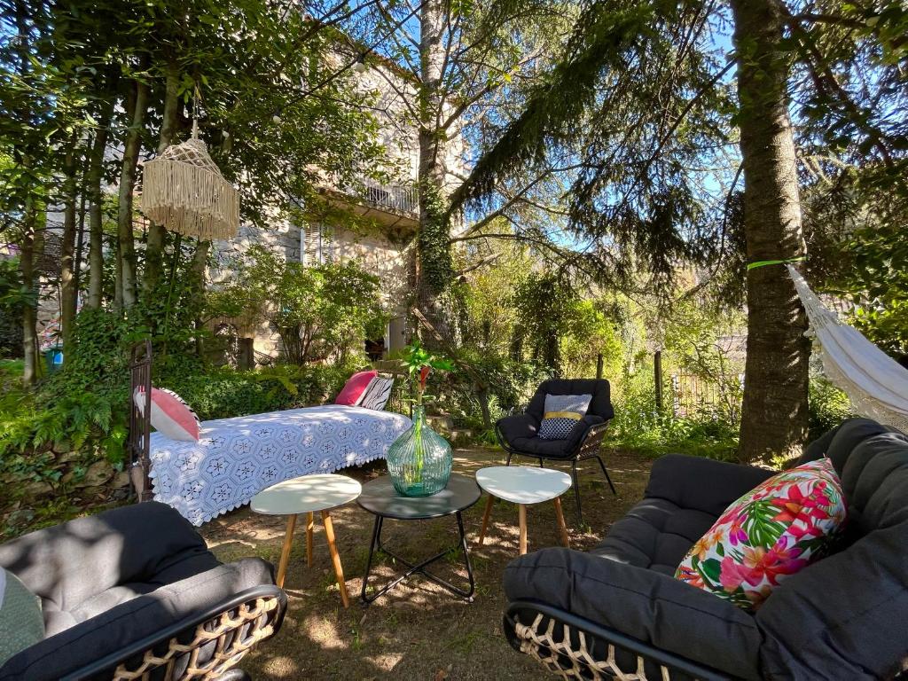 a patio with couches and a table and chairs at Housica & Co. in Ucciani