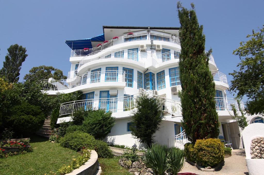 a white building with a lot of windows at Villa White Dove in Golden Sands