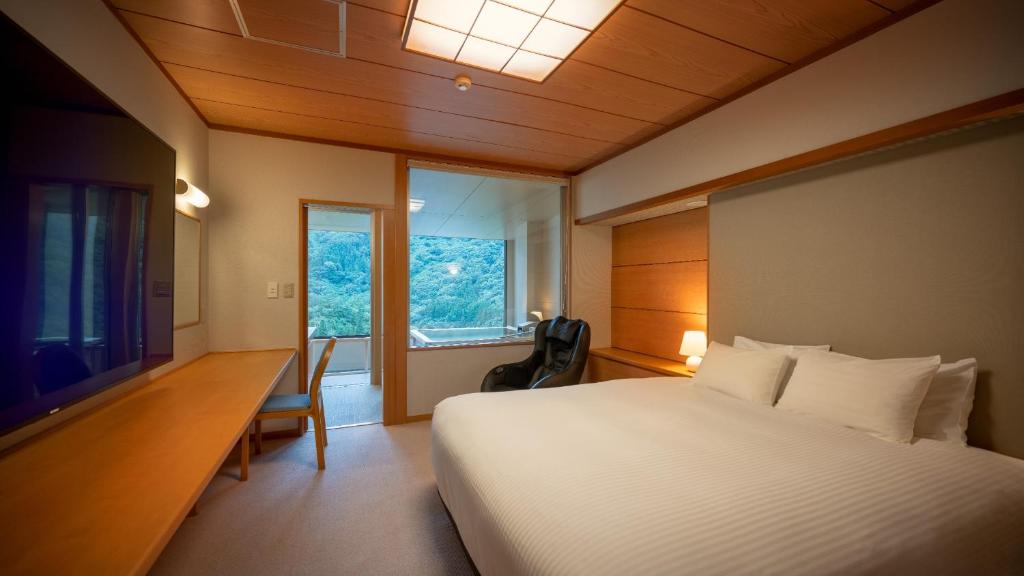Postel nebo postele na pokoji v ubytování Marumine Kanko Hotel