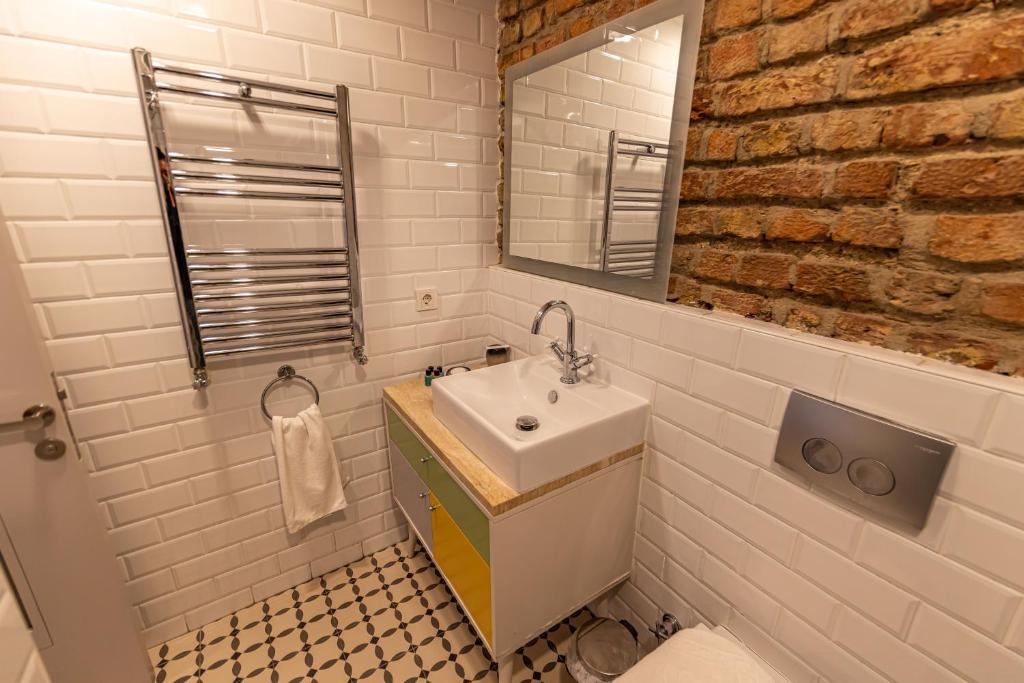 a bathroom with a sink and a mirror at Calanthe Residence in Istanbul