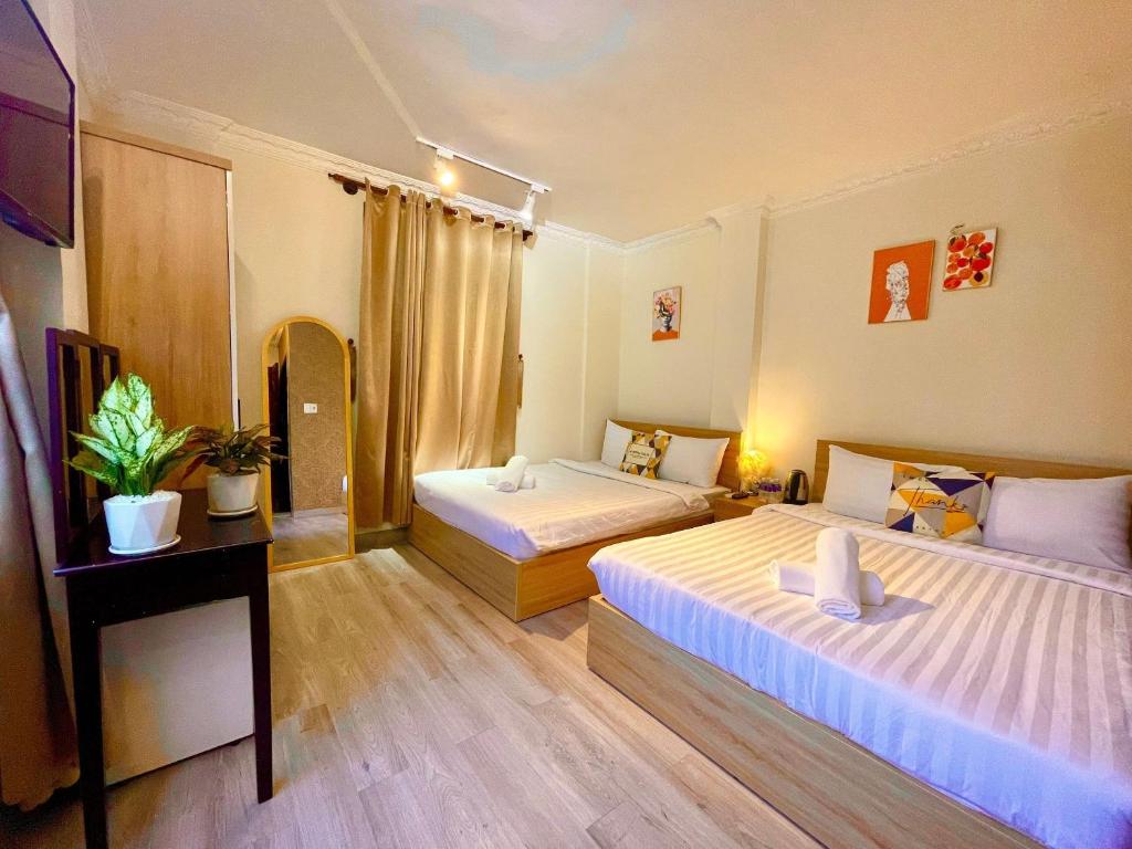 a hotel room with two beds and a television at Anh Thien Sai Gon Central Hotel - District 1 in Ho Chi Minh City