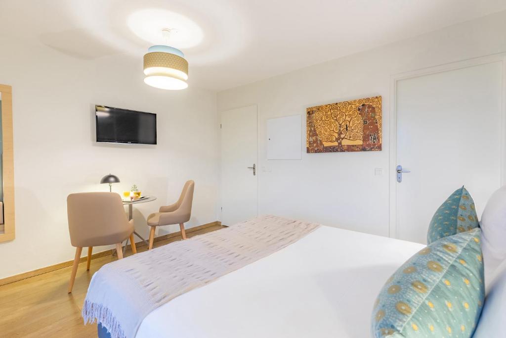 Una cama o camas en una habitación de Appart'City Confort Toulouse Purpan