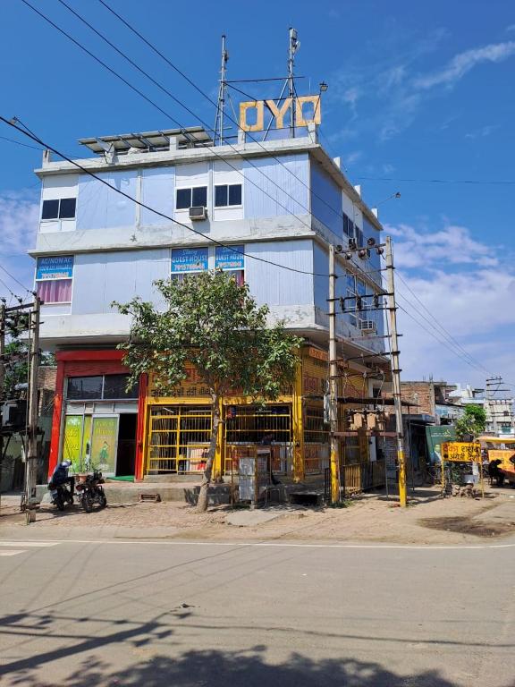 a building on the side of a street with a tree at Stacy Guest House in Jīnd