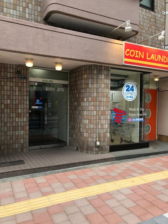 a store front of a building with a sign on it at Hatoya Hotel in Tokyo