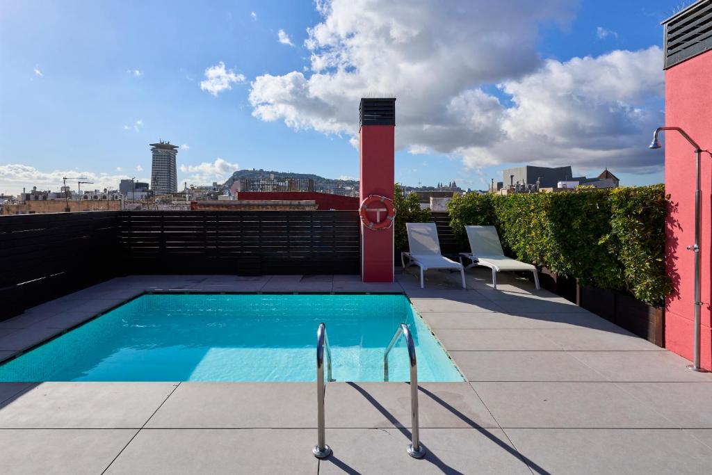 a swimming pool on the roof of a building at Catalonia Avinyo in Barcelona
