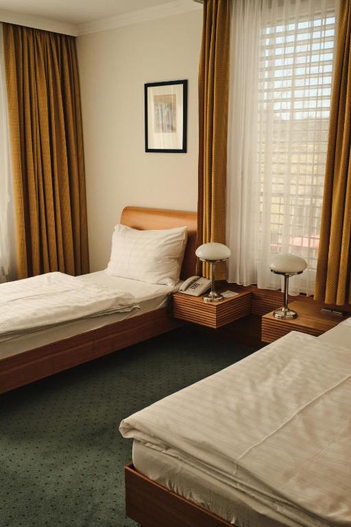 Postel nebo postele na pokoji v ubytování Hotel Exel