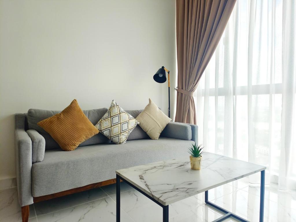a living room with a couch and a table at One Bedroom Troika Kota Bharu by AGhome, Modern Design in Kota Bharu