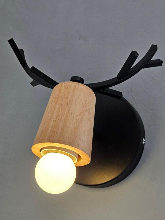 a ceiling light with a black and wooden shade at Ocean Star B&amp;B in Kenting