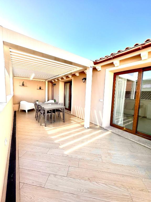 a patio with a table and chairs on a house at Waterfront apartment Olbia in Olbia