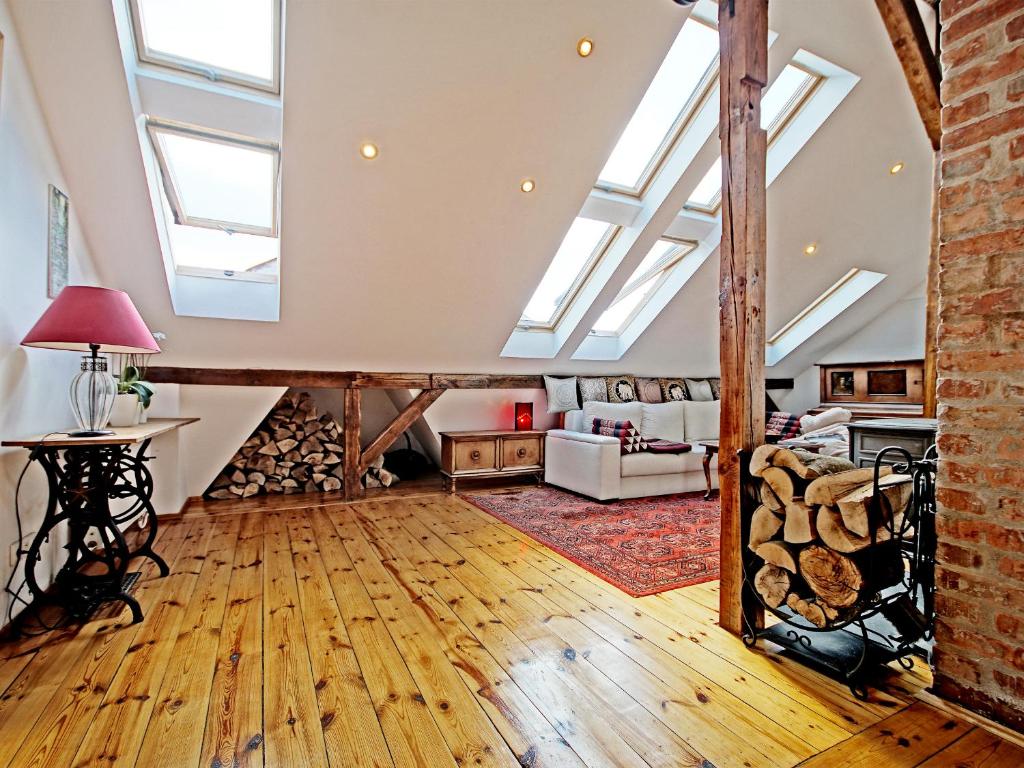 an attic room with skylights and wood floors at Sopot Apartment SA in Sopot