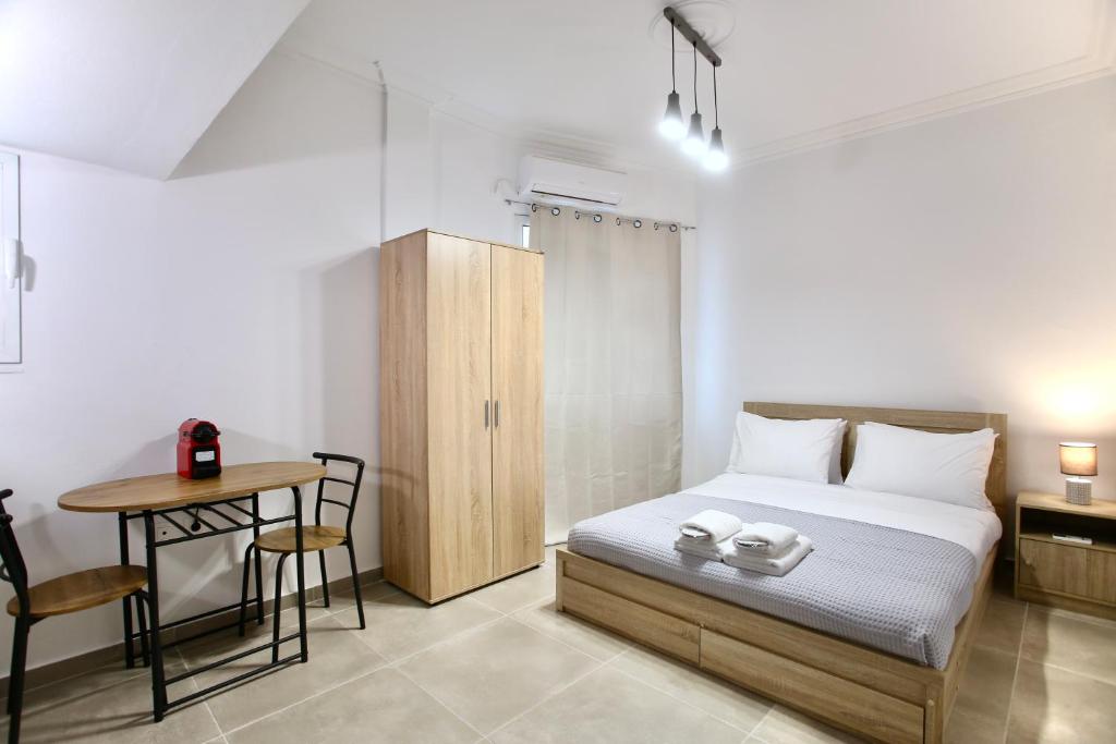 a bedroom with a bed and a desk and a table at GK Attica in Athens