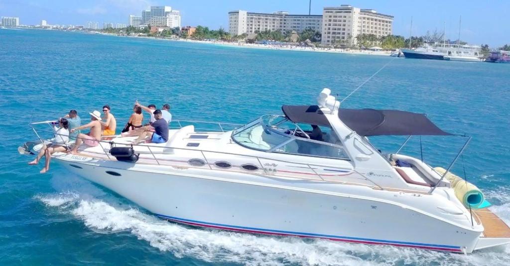 a group of people on a boat in the water at Billionaire Yach Resort - Muelle Marina Puerto Cancun in Cancún