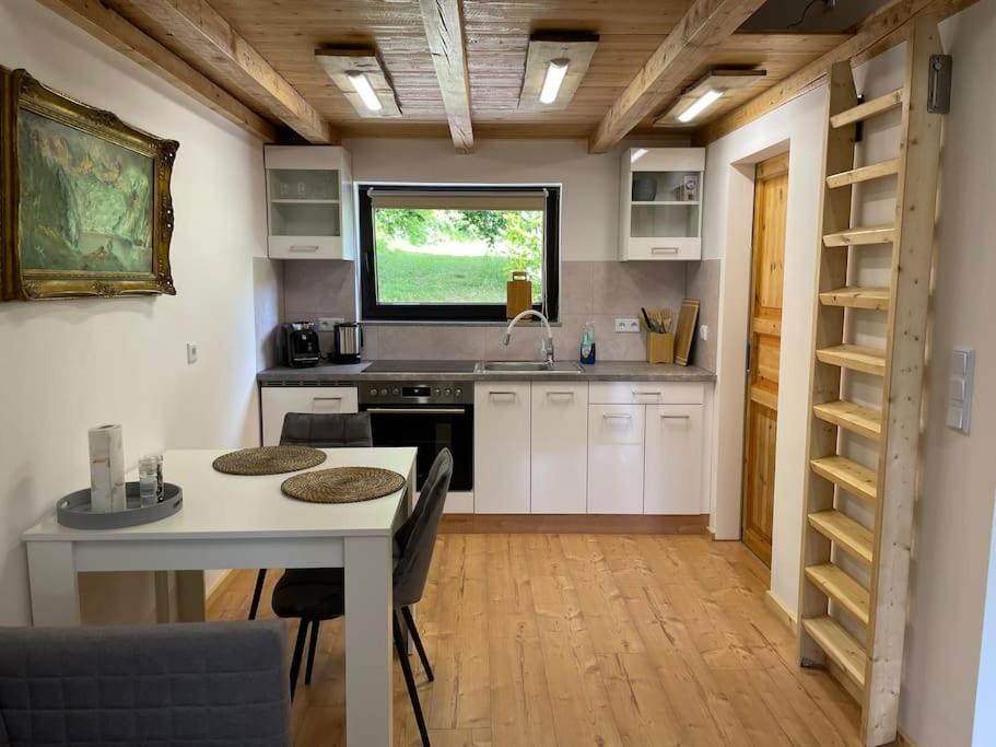 a kitchen with a table and a sink and a window at Appartement zur Wied in Oberlahr