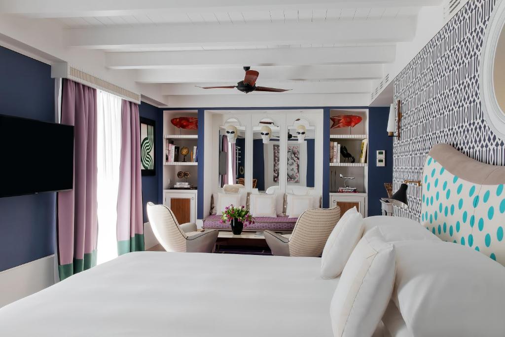 a bedroom with a bed and a living room at Capri Tiberio Palace - The Leading Hotels of the World in Capri