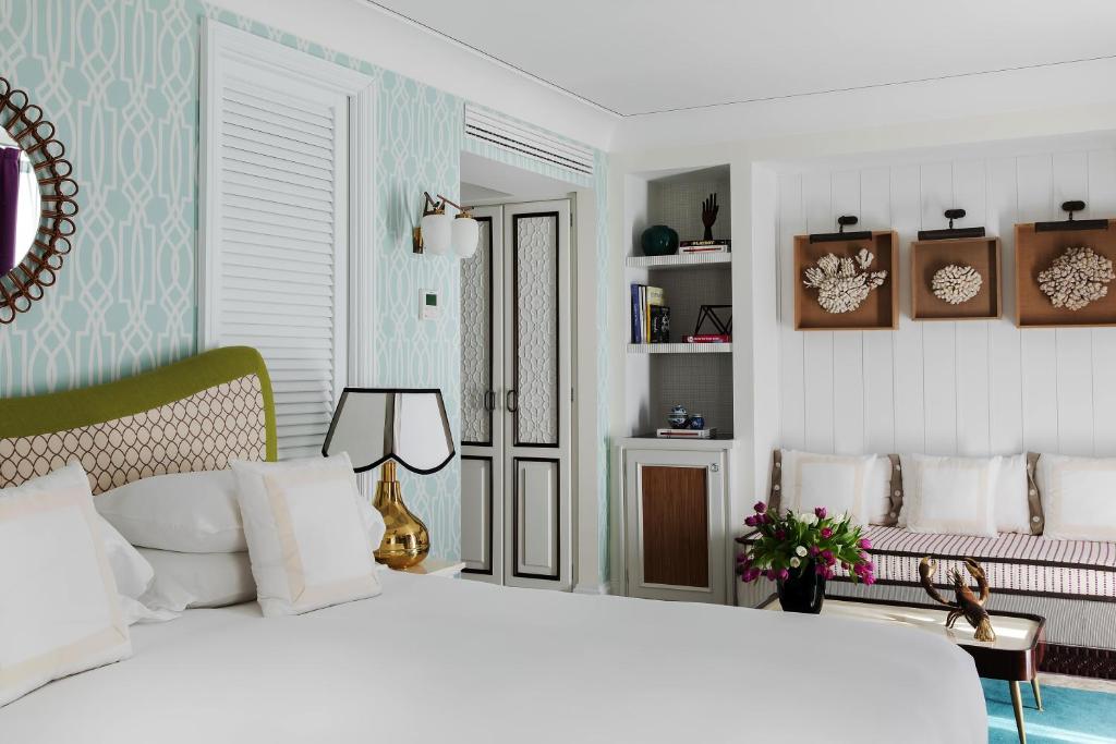 a bedroom with a large white bed with white pillows at Capri Tiberio Palace - The Leading Hotels of the World in Capri