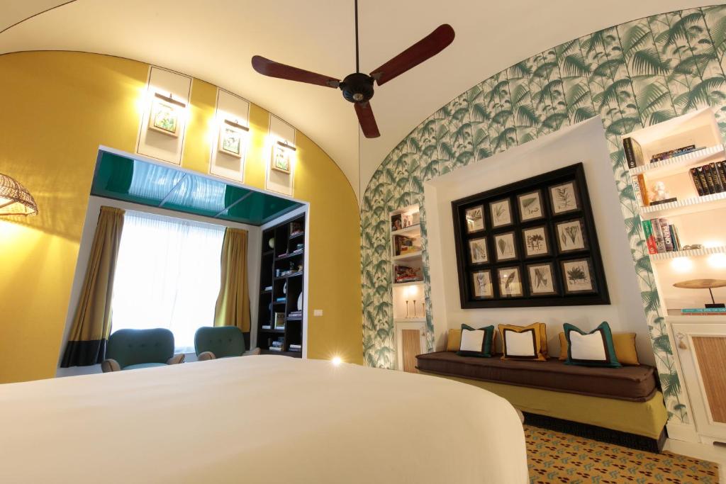 a bedroom with a large bed and a window at Capri Tiberio Palace - The Leading Hotels of the World in Capri