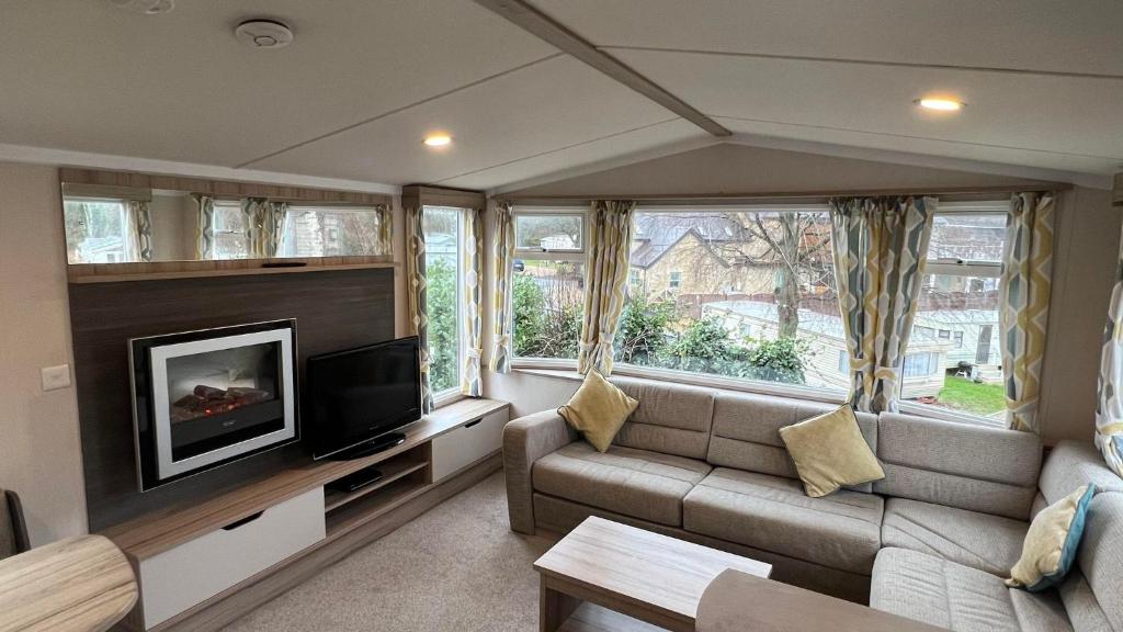 a living room with a couch and a flat screen tv at Beamish Holiday Park in Stanley