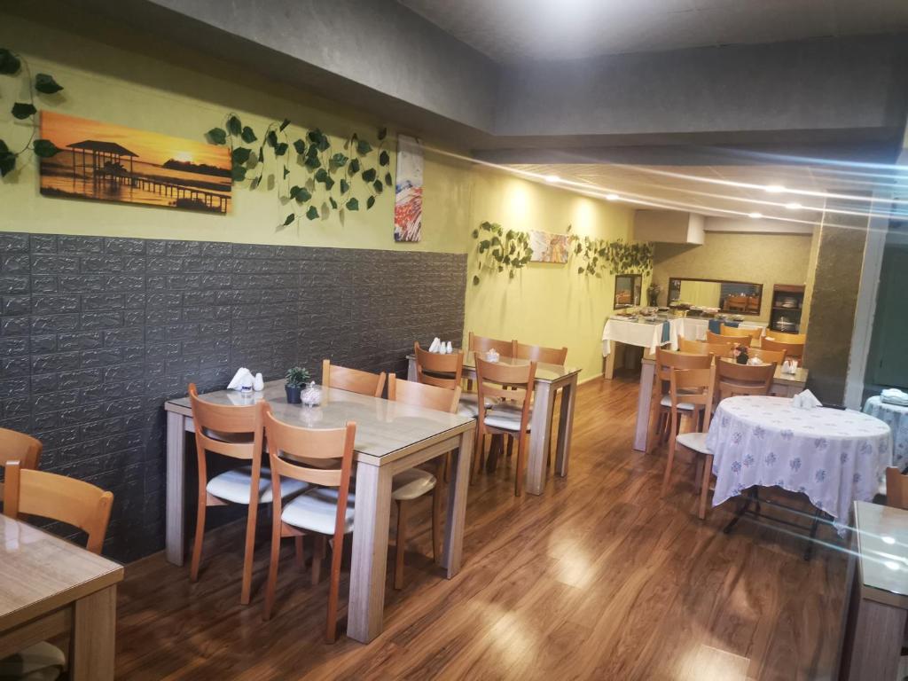 a dining room with tables and chairs in a restaurant at ADOR TROIA HOTEL in Çanakkale