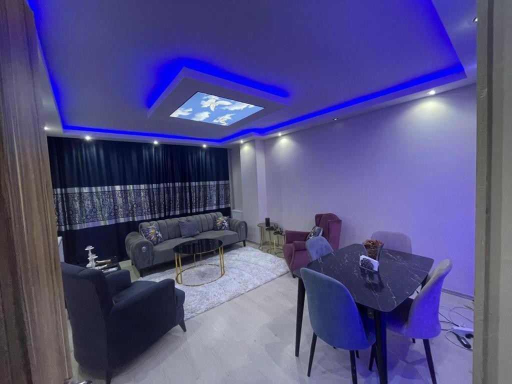a living room with purple lighting and a table and chairs at Super Cozy Large Double Bedroom ONLY with Shared Facilities-Free Wifi, Netflix - Many local Shops in Esenyurt