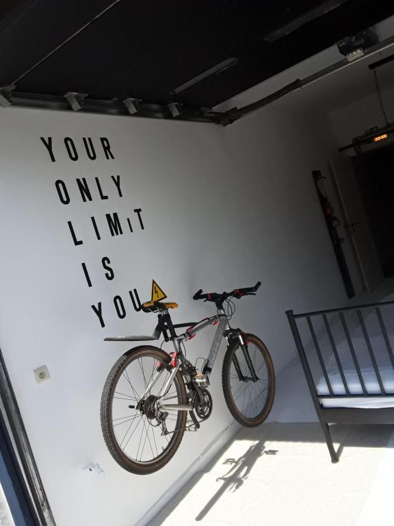 a bike parked on a wall next to a chair at Bij Sarah in Leopoldsburg