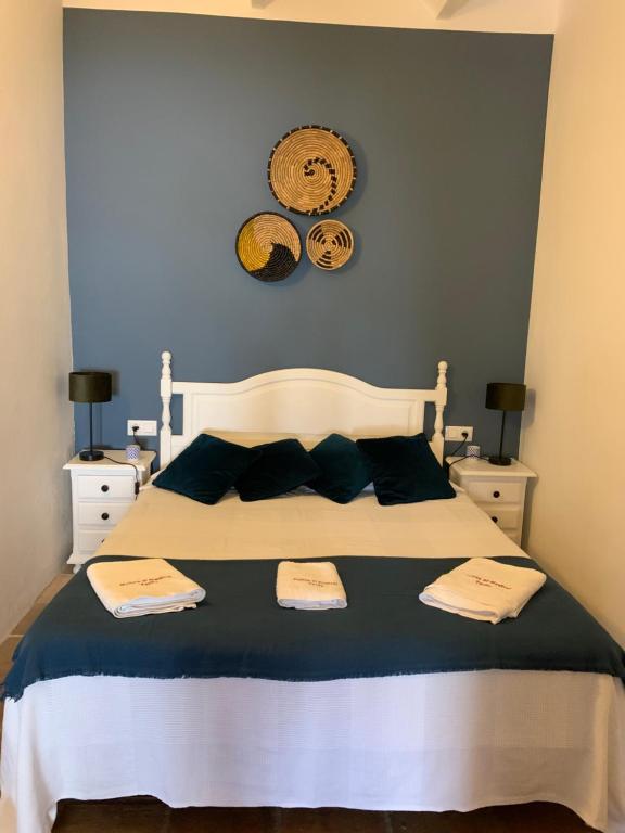 a bedroom with a bed with two towels on it at Molino El Mastral in Tarifa