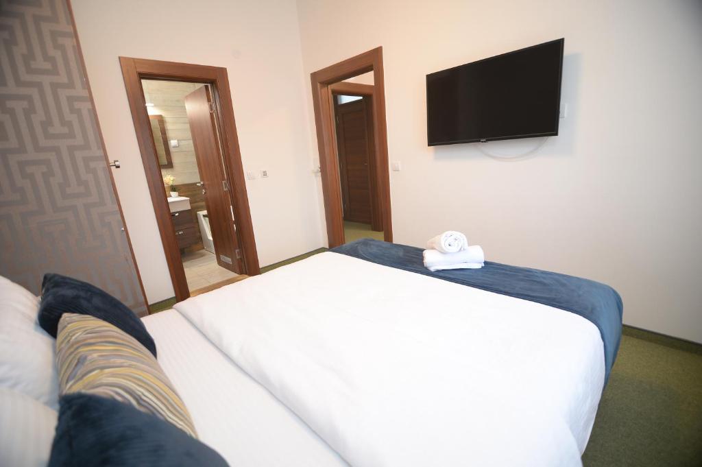 Postel nebo postele na pokoji v ubytování Apartmani Čarolija
