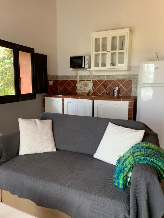a living room with a couch and a kitchen at Molino El Mastral in Tarifa