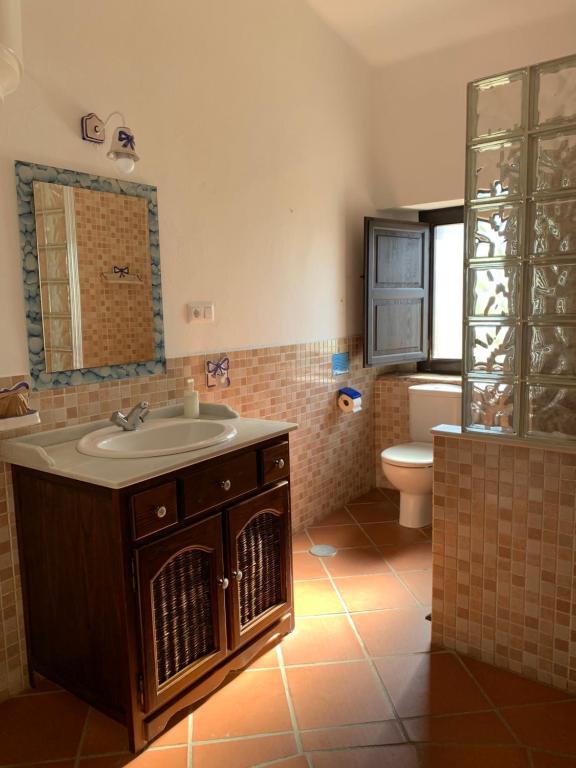 a bathroom with a sink and a toilet at Molino El Mastral in Tarifa