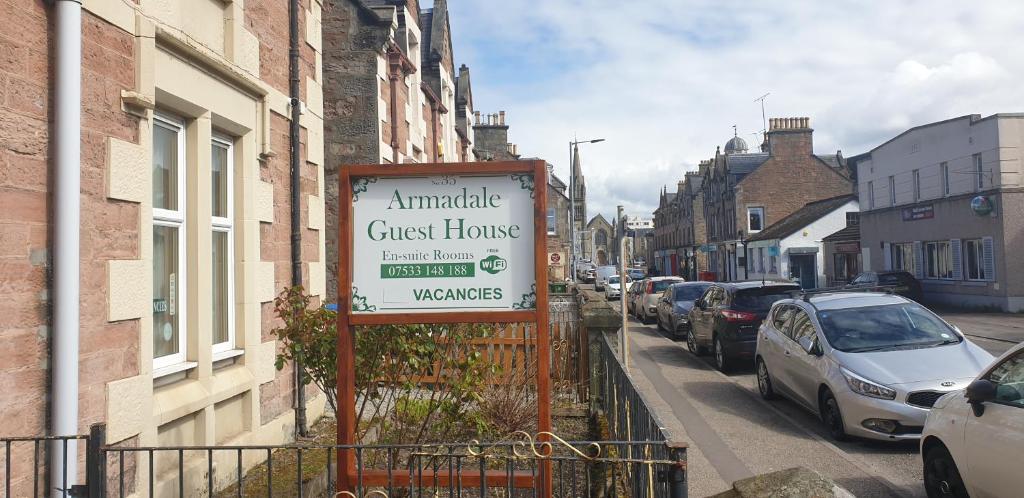 a sign for a guest house on a street at Armadale Guest House in Inverness