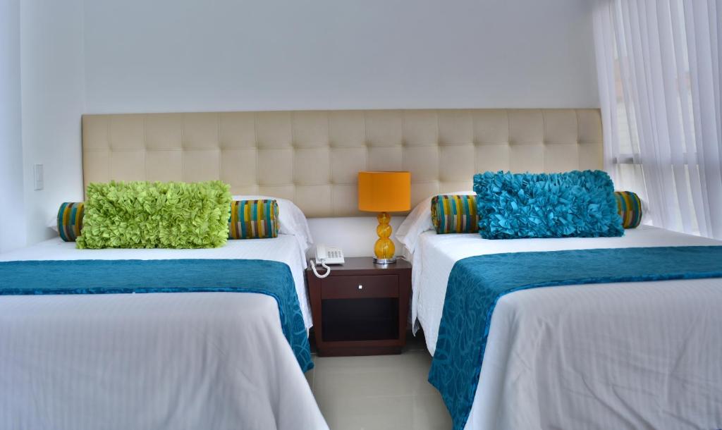 Postel nebo postele na pokoji v ubytování Monterosa Apartamentos Amoblados