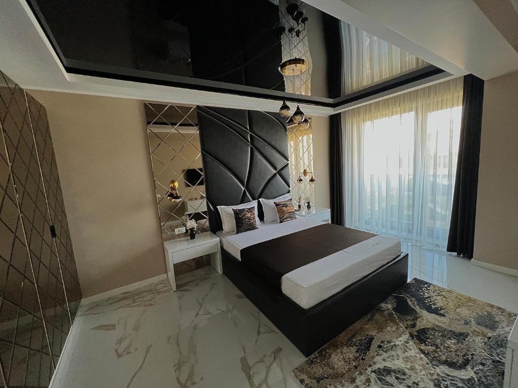 a bedroom with a bed and a large window at CSO Luxury Residence in Mamaia