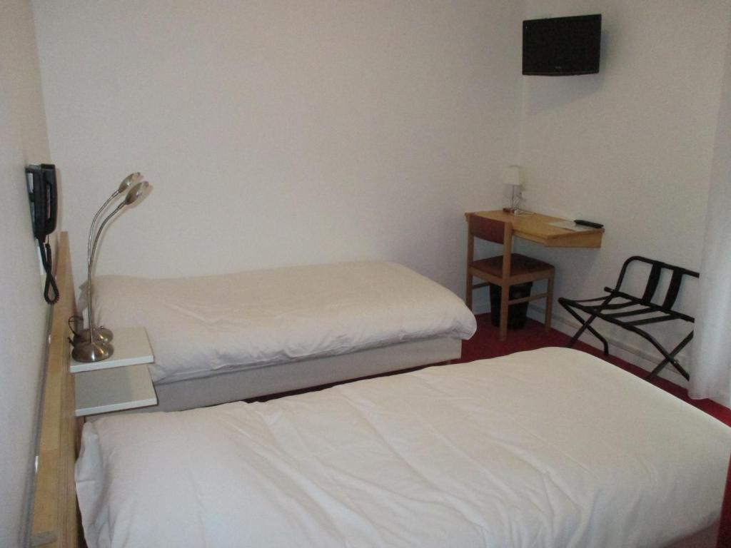 Postel nebo postele na pokoji v ubytování Hôtel Chez Pierre d'Agos