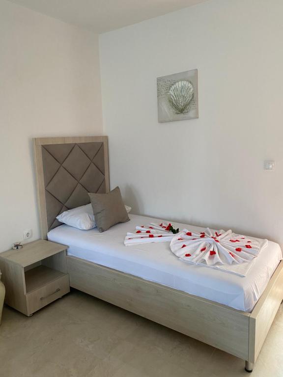 a bedroom with a bed with candy canes on it at Apartments Gusar in Ulcinj