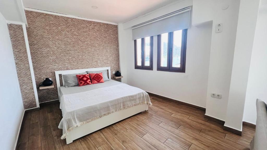 a bedroom with a bed with red pillows on it at Vista House Marmaris in Marmaris