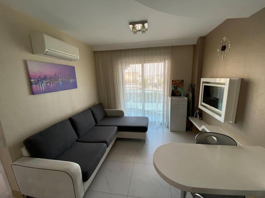 a living room with a couch and a table at Granada City’de modern lüx 1+1 in Alanya