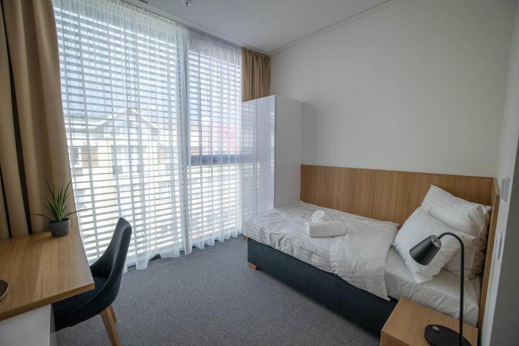 Postel nebo postele na pokoji v ubytování Hotel Smetanova