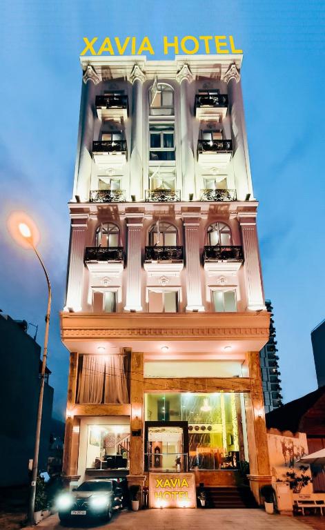 a building with a hotel with four levels at Xavia Hotel Quy Nhơn in Quy Nhon