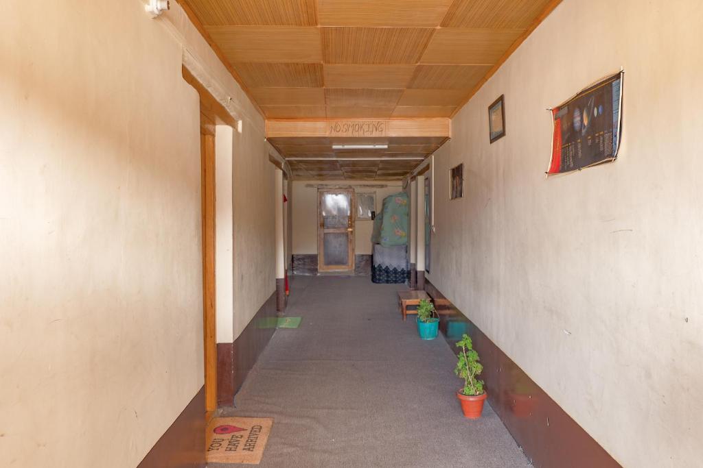 an empty hallway of a building with a wooden ceiling at Astrostays at Pangong in Spangmik