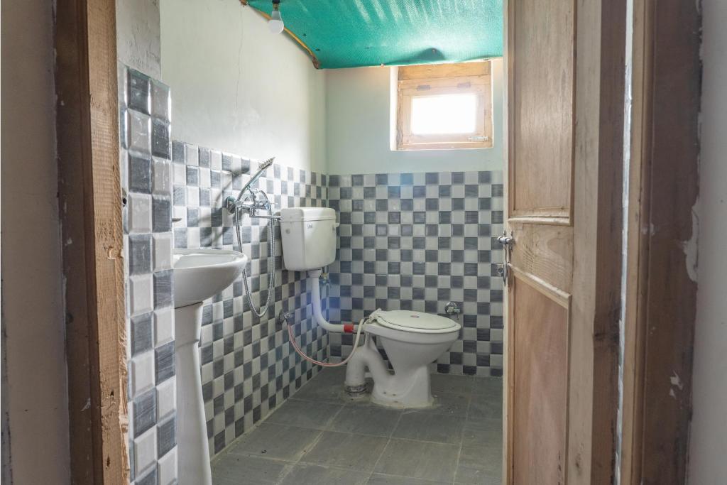 a bathroom with a toilet and a sink at Astrostays at Pangong in Spangmik