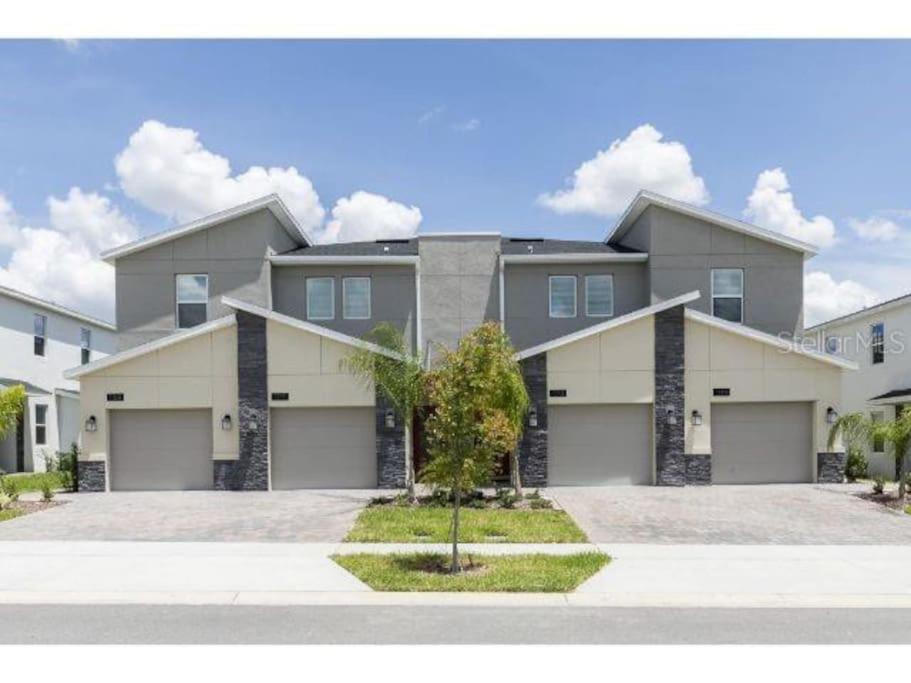 a large house with a driveway in front of it at Luxury Champions Gate Condo-Disney Firework Views! in Kissimmee