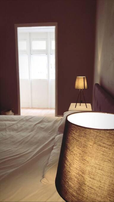 a bedroom with a bed and a table with a lamp at Valletta Archbishop 2 in Valletta