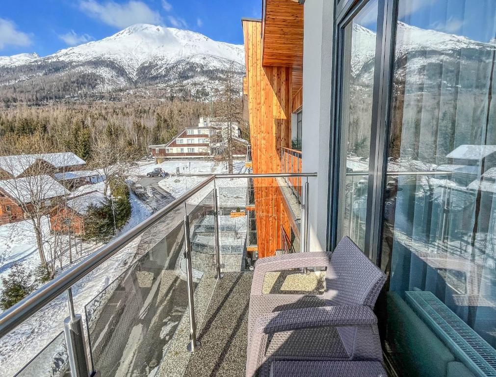 a balcony with a view of a snowy mountain at Hotelový apartmán ALFRED C407 in Vysoke Tatry - Stary Smokovec