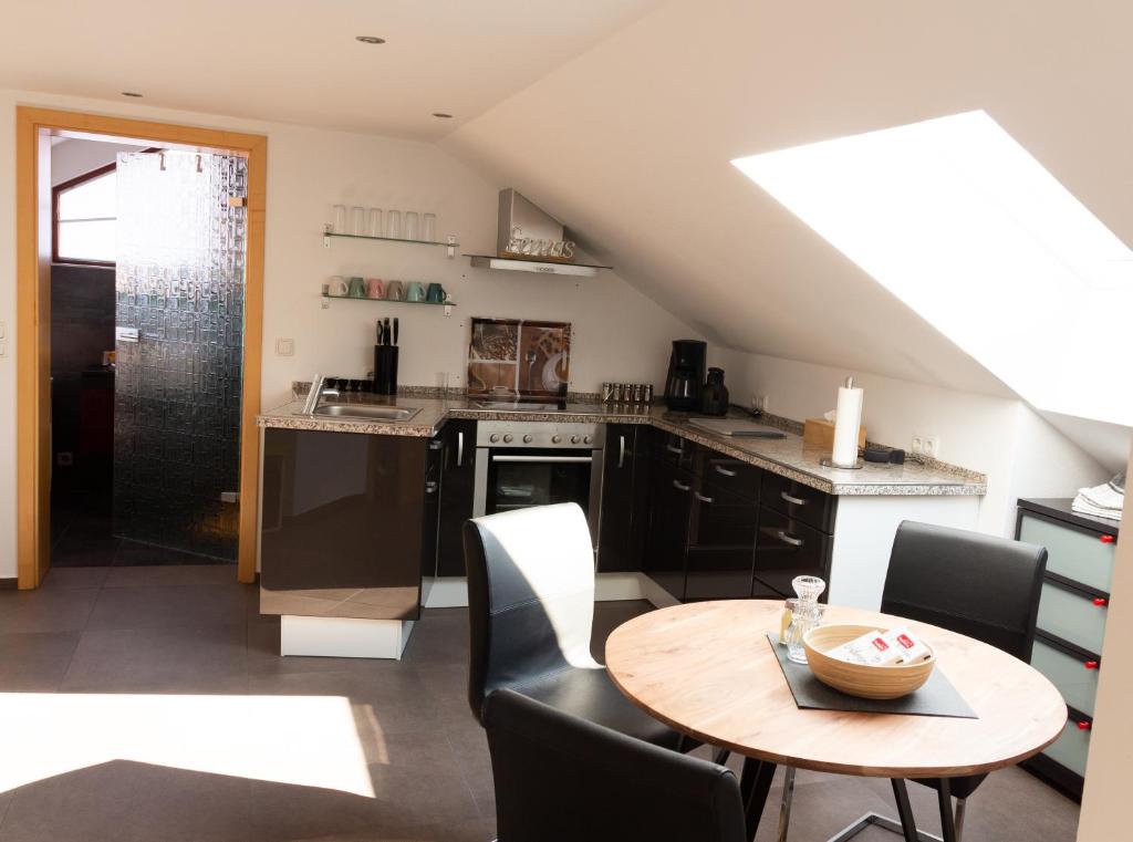 a kitchen with a table and a dining room at Baumeister`s Ferienwohnung in Niederlauer