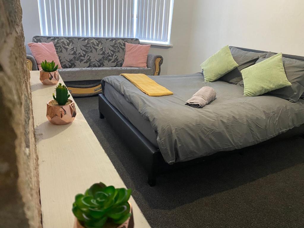 a living room with a bed and a couch at Coventry Spacious House in Coventry