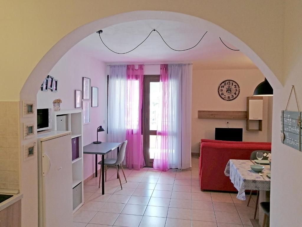 a living room with a red couch and a table at Apartment Suzie Q - Intermezzo with sea view in Rabac